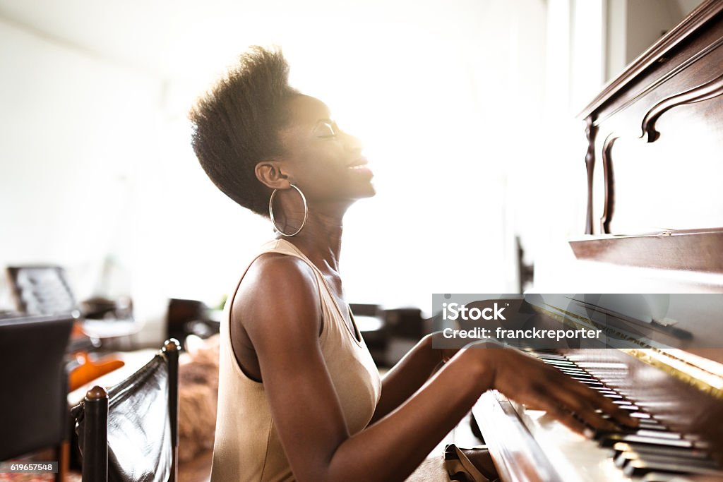 woman playing the piano Piano Stock Photo