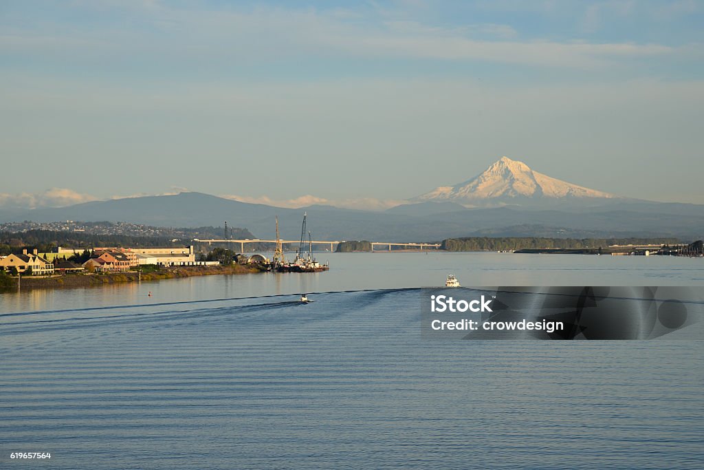 Mount Hood and the Columbia River Looking toward Mount Hood in Oregon from the Columbia River at Vancouver, WA, USA Two small boats on the water. The I-205 Glenn Jackson Bridge in the background. Washington State Stock Photo