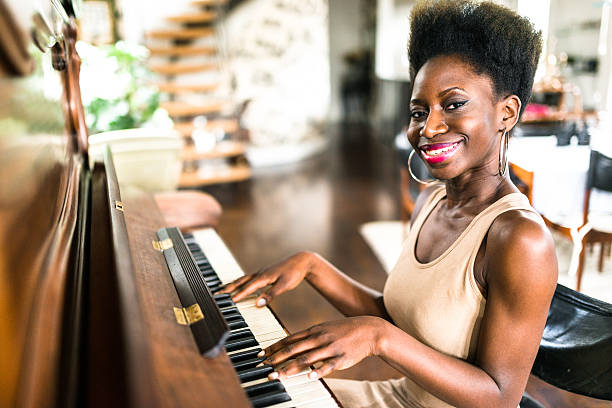 istock woman playing the piano 619657638