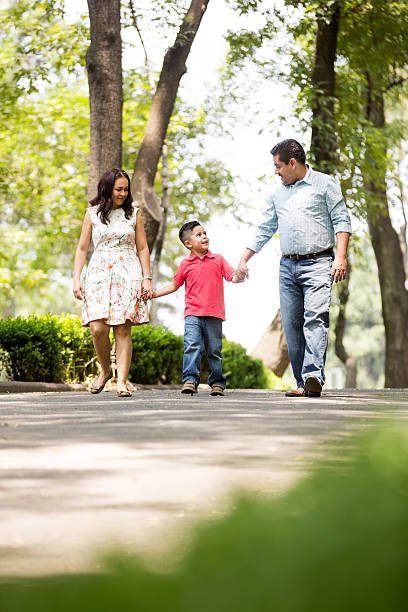 istock Family with one child walking hand in hand 619657648
