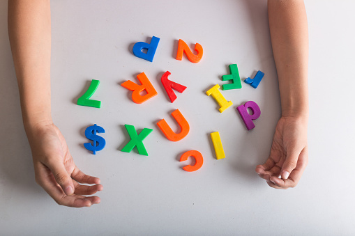 girl playing letters on table