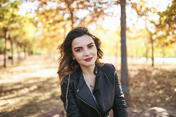 istock Young beautiful woman on forest look at camera 619659842