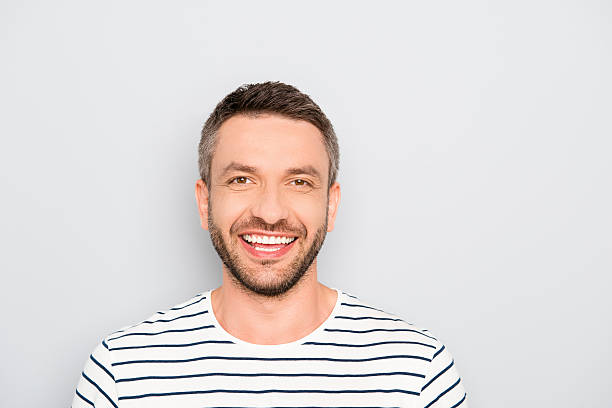 istock Happy man with beaming smile isolated on gray background 619659856