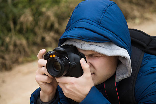 istock photographer is taking photo on DSLR camera 619660018