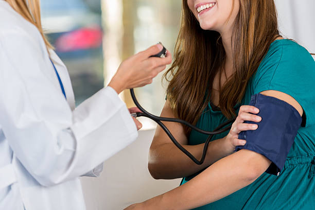 istock Pregnant woman's prenatal appointment 619660106
