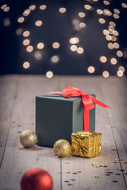 istock christmas decorations and green present on wood 619661608