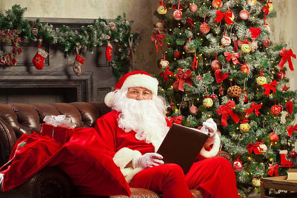 istock Santa Claus sitting at his home in a comfortable chair 619663838