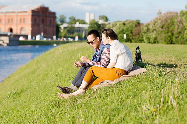 istock The loving couple is sitting on the grass. 619665682