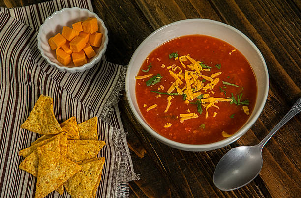 istock White bowl of tomato soup with crackers and cheese 619666078