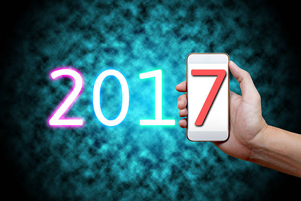 istock 2017 Happy New Year Concept, Hand holding mobile phon 619666114