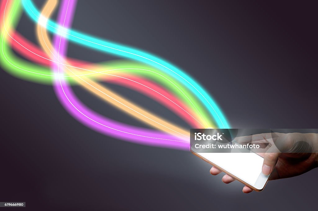 Man holding mobile phone and fiber optical light network. Bandwidth Stock Photo