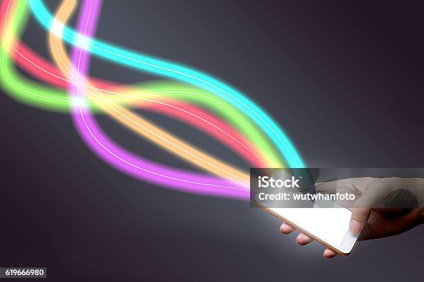 Man Holding Mobile Phone And Fiber Optical Light Network Stock Photo - Download Image Now