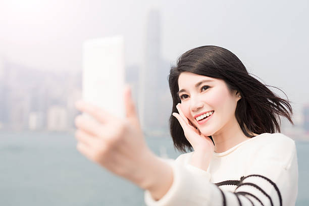 istock beauty woman smile and selfie 619667500