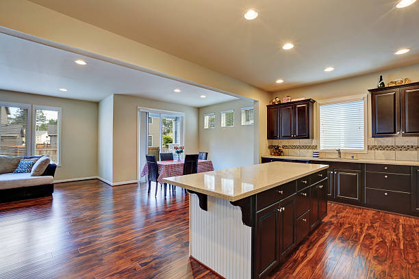 istock Kitchen and dining room interior with dark tone hardwood floor. 619668542