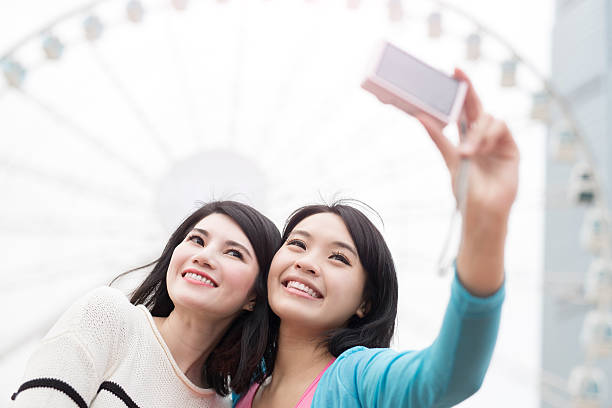 istock two woman selfie in hongkong 619668962