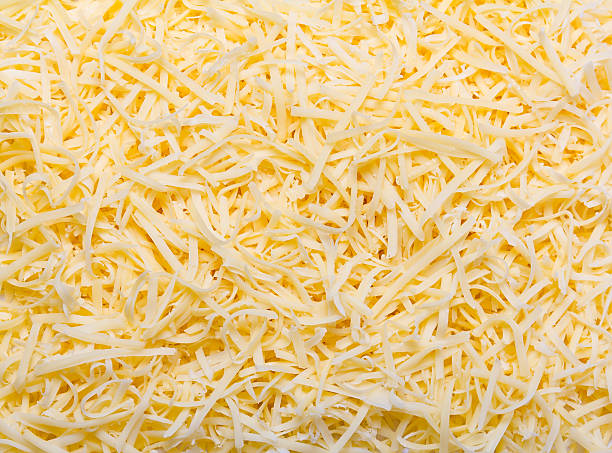 Grated pizza cheese Heap of Grated pizza cheese close up texture mozzarella stock pictures, royalty-free photos & images
