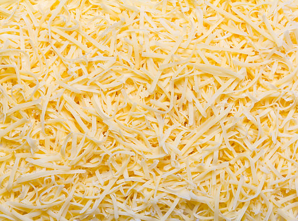 Grated pizza cheese Heap of Grated pizza cheese close up texture grated stock pictures, royalty-free photos & images