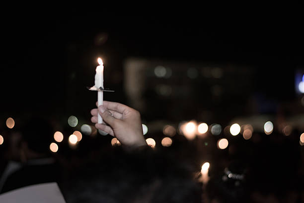istock Blurred image for background of hand with candle memorable 619670246