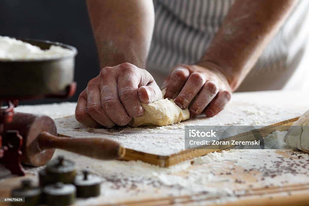 Close up of male baker hands kneading dough Close up of male baker hands kneading the dough with flour powder. Bread Stock Photo