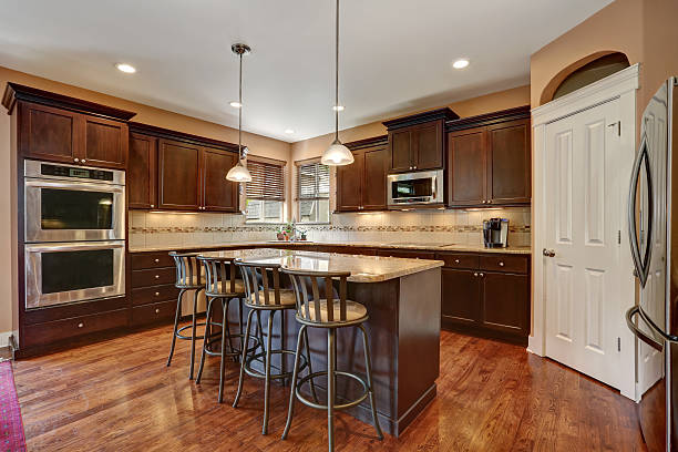 istock Well remodeled kitchen room interior with dark wood cabinets 619672706