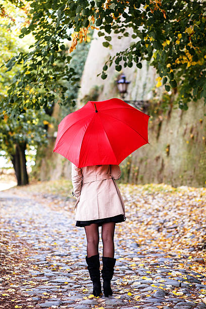 istock Woman with red umbrella 619673920