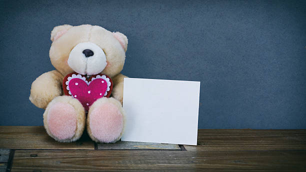 istock Teddy bear and white paper sticker 619674524