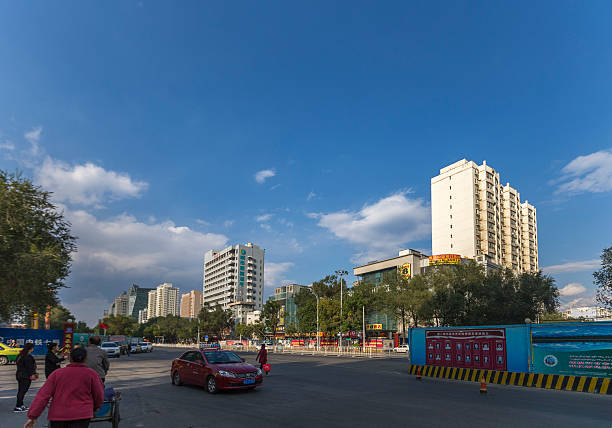 Urumqi, Xinjiang, China - October 4, 2016: Urumqi street view. Bus and Taxi on the road, business buildings on the road sides, incidental people on the background.