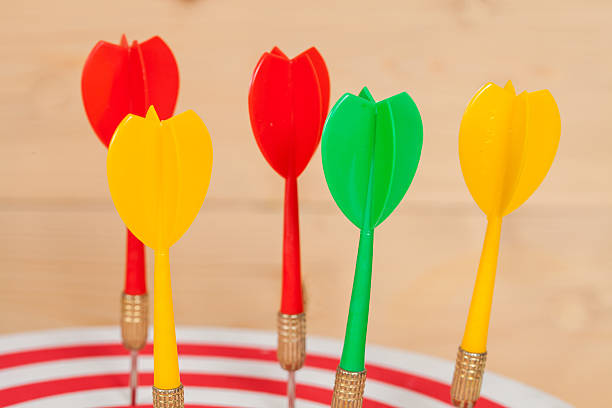 istock dart arrow and dartboard on wood background 619727204