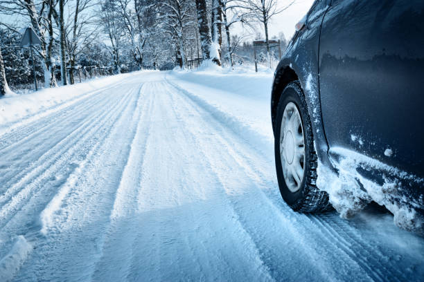 istock Car tires on winter road 619727498
