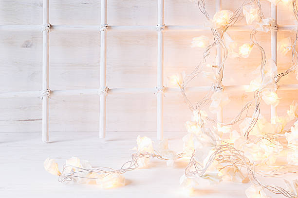 istock Christmas  home decor with lights burning  on  white wooden background. 619728252