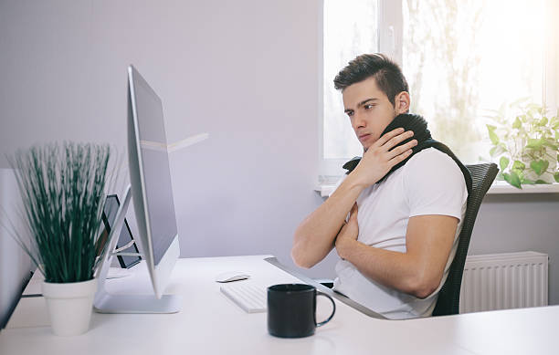 istock Young worker with a cold. Freelancer in  scarf and   cup 619731024
