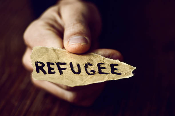 istock piece of paper with the word refugee 619731048