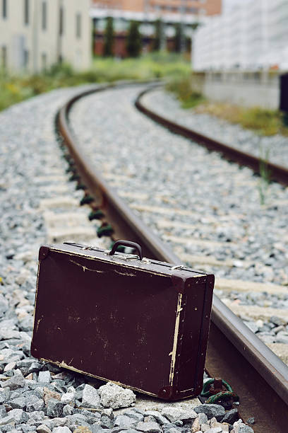 istock suitcase next to the railroad tracks 619731118