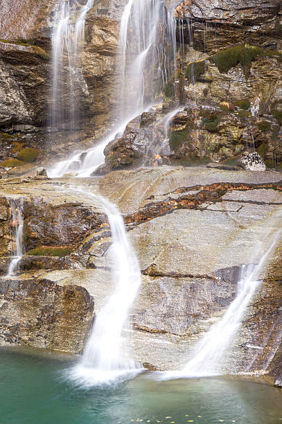 istock waterfall in the mountains and the autumnal trees, long exposure 619731124