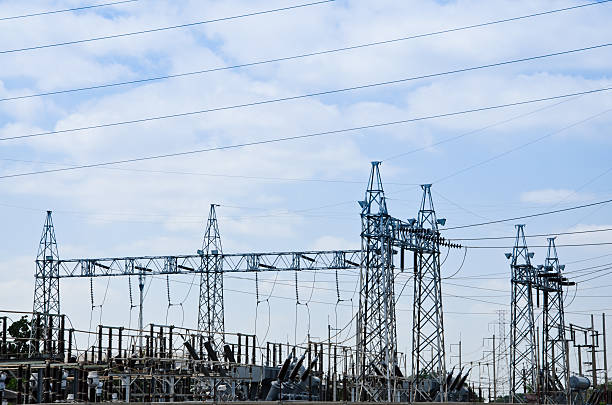 istock High voltage power lines with electricity pylons at blue sky. 619731516