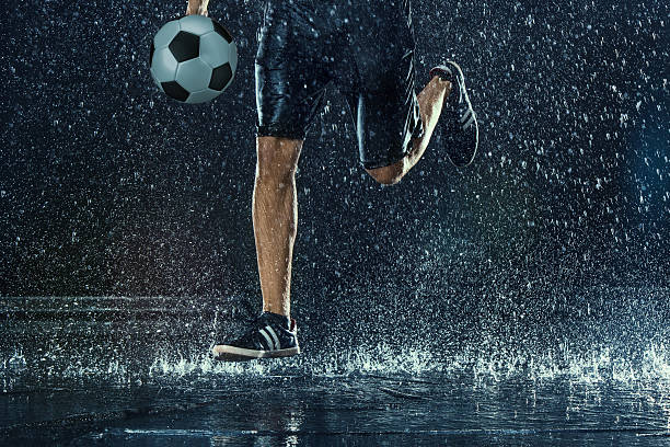 istock Water drops around football player 619732542