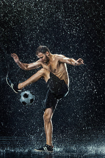 istock Water drops around football player 619733550