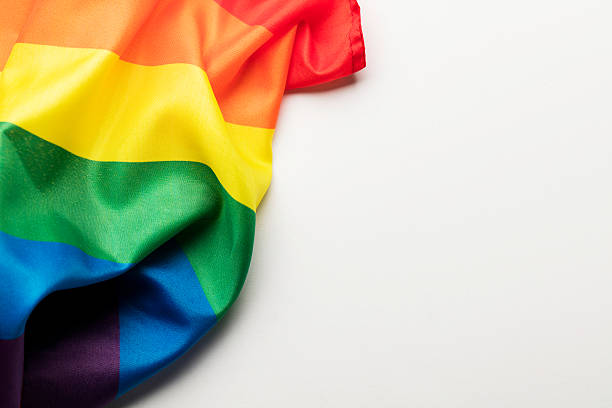Photograph of the LGBT rainbow flag, lesbian, gay, bisexual and transgender on a plain background