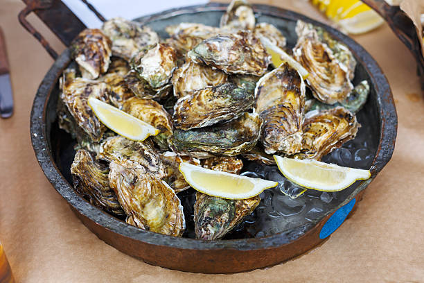 istock Plenty of seafood, oysters on grill pan 619734572