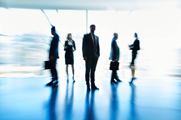 istock Blurred business people in office lobby 619735068