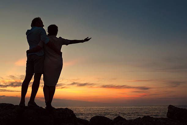 Inlove couple on the seacoast at sunset time