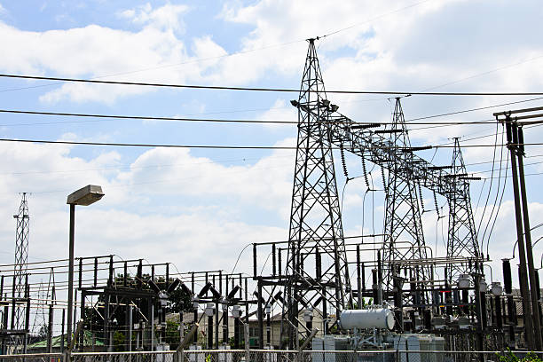 istock High voltage power lines with electricity pylons at blue sky. 619735424