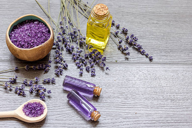istock Essential oil and lavender salt with flowers top view 619735528
