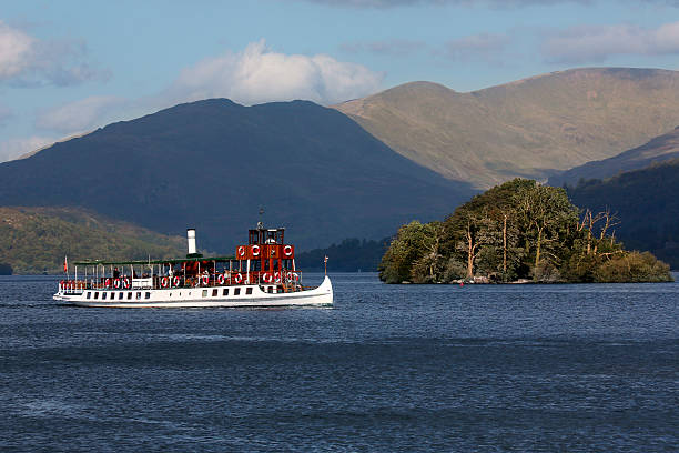 Bowness, United Kingdom - October 5, 2016: Tourist boat near Bowness on Lake Windermere in the Lake District in Cumbria in the northwest of England in the United Kingdom. Windermere is the largest natural lake in England and is within the Lake District National Park.