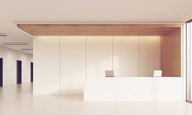 istock Front view of sunlit reception desk in corridor 619736326