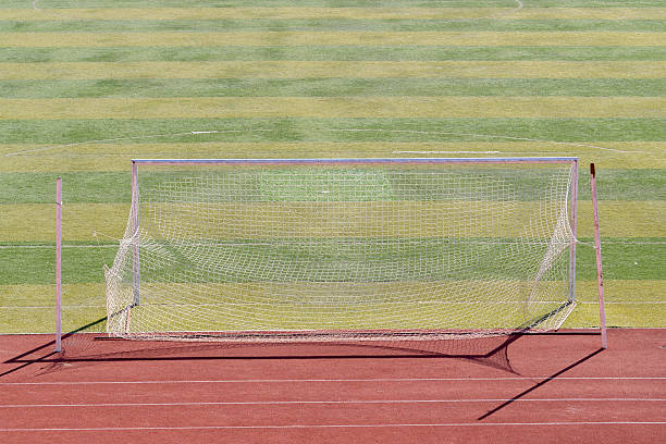 istock goal gate on football pitch 619736616