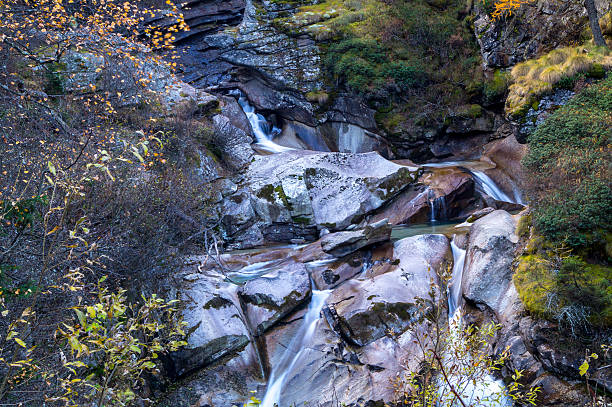 istock mountain stream, long exposure silky water, autumn colors 619736670