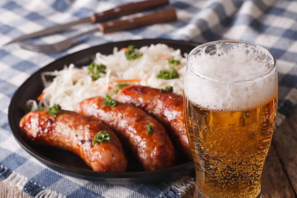 Lager beer and snacks of sausages and sauerkraut Lager beer and snacks of sausages and sauerkraut on the table close-up. horizontal german food photos stock pictures, royalty-free photos & images