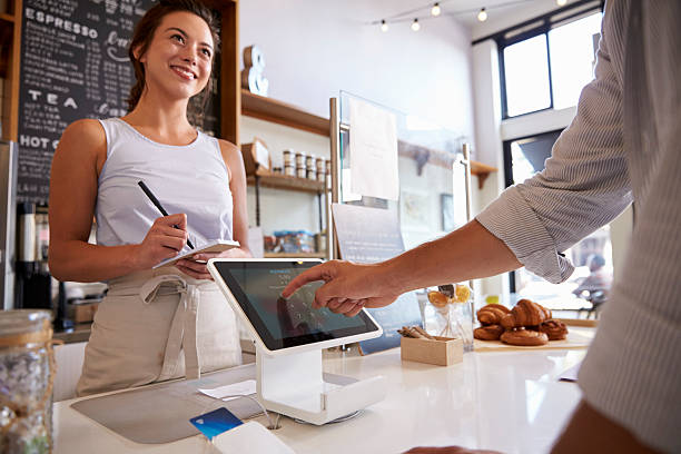 customer using touch screen to make payment at a coffee - credit card reader imagens e fotografias de stock