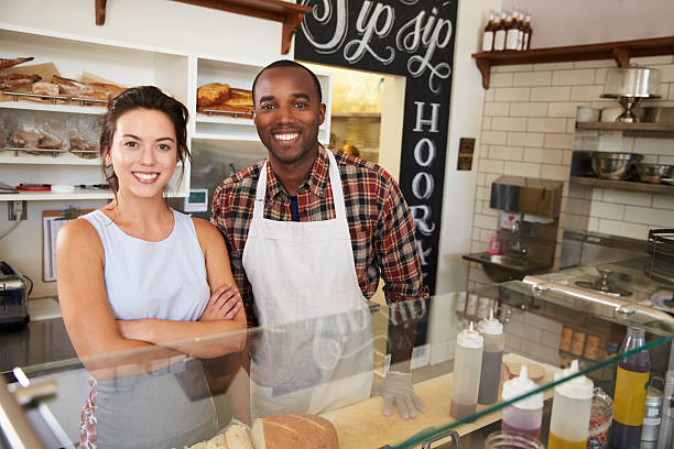 istock Mixed race couple behind the counter at a sandwich bar 619738424